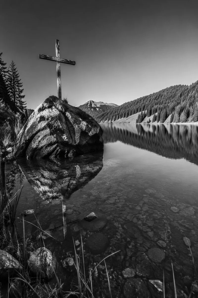 Weathered Cross Reflected in Mountain Lake