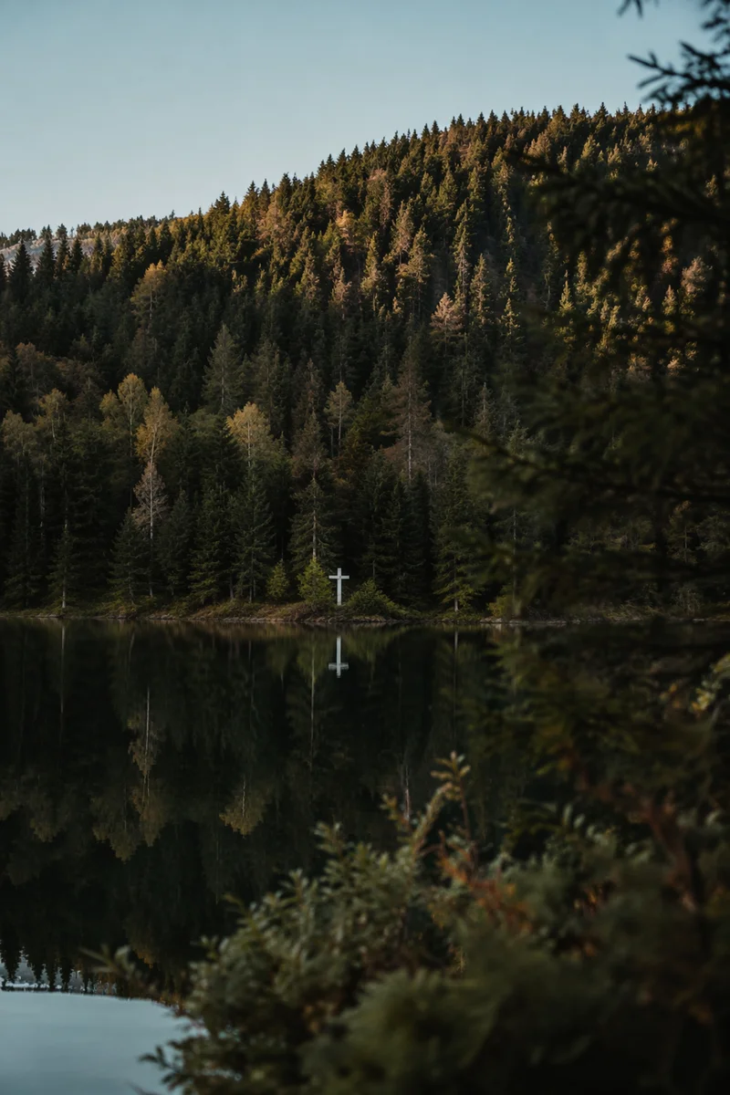 White Cross Reflected in Mountain Lake