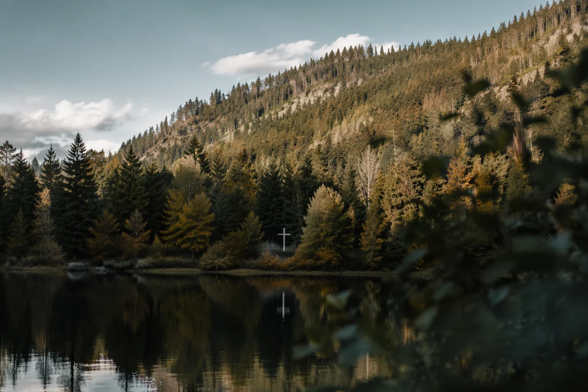 White Cross Reflected in Still Mountain Lake