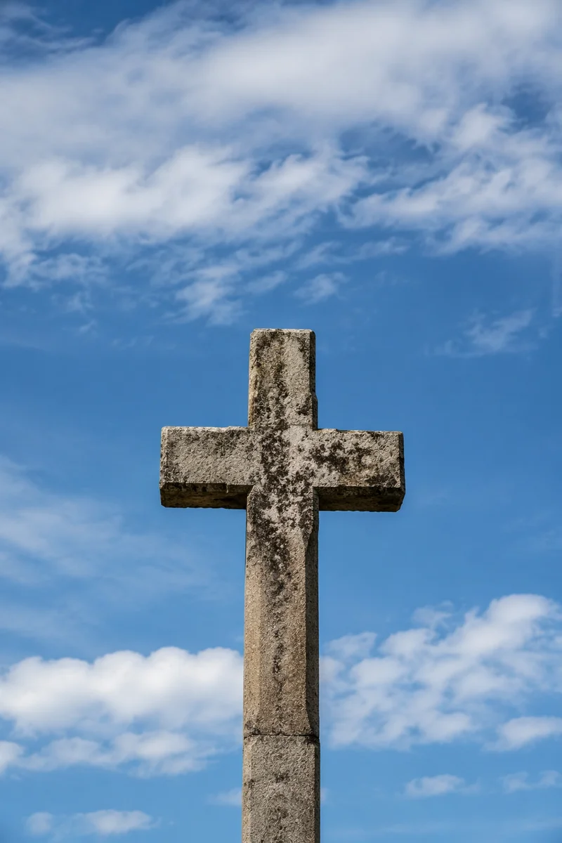 Weathered Stone Cross Under Blue Sky