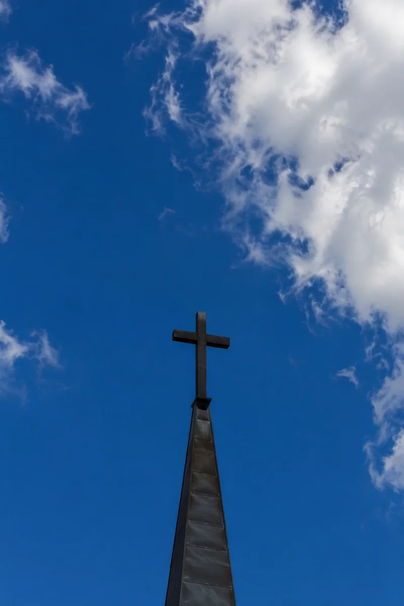 Cross on Steeple Under Blue Sky