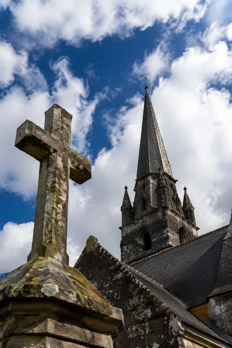 Weathered Stone Cross Beneath Blue Sky