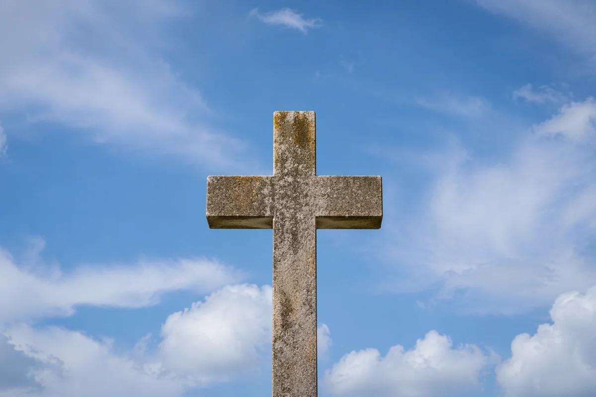 Weathered Stone Cross Under Blue Sky