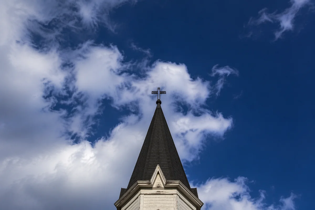 Empty Cross Steeple Under Blue Sky