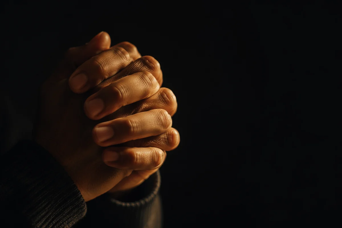 Folded Hands in Warm Candlelight Prayer