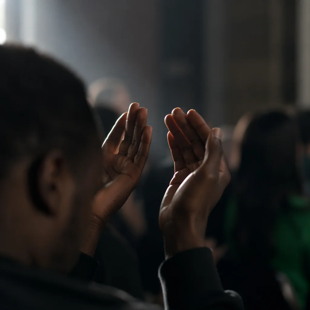 Dark Hands Raised in Quiet Prayer