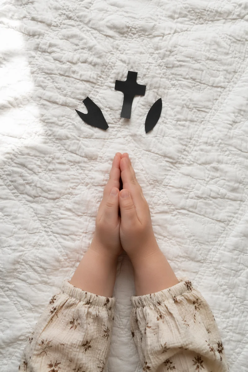 Child Hands Praying in Soft Window Light