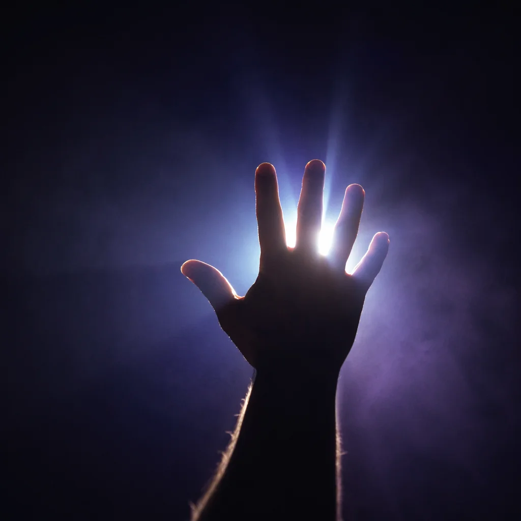 Silhouette Hand Reaching Toward Divine Light