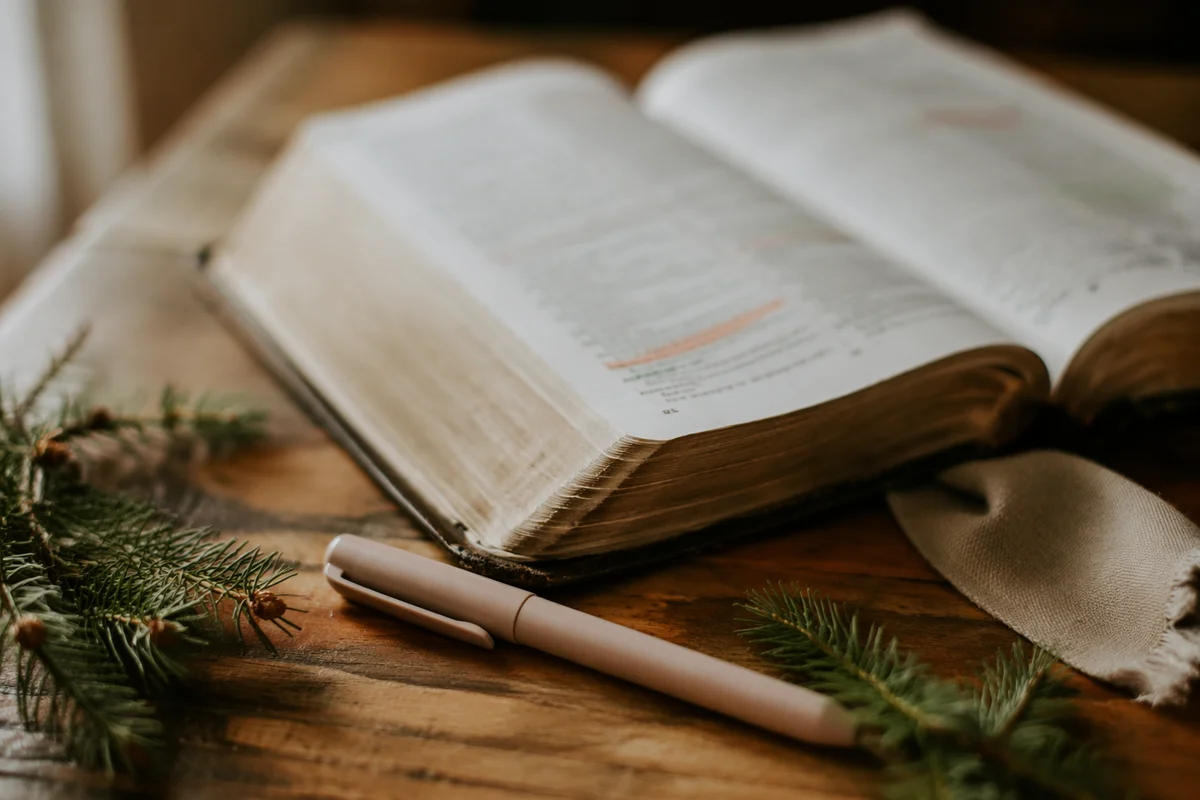 Open Bible with Marker and Evergreen