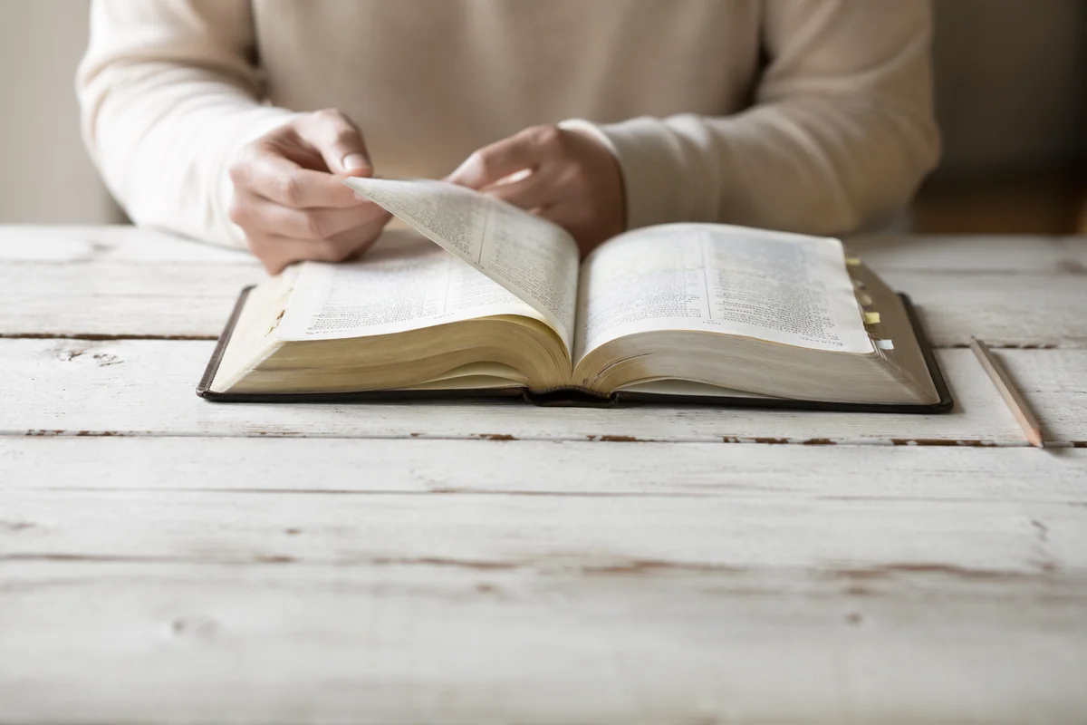 Open Bible on Rustic Wooden Table