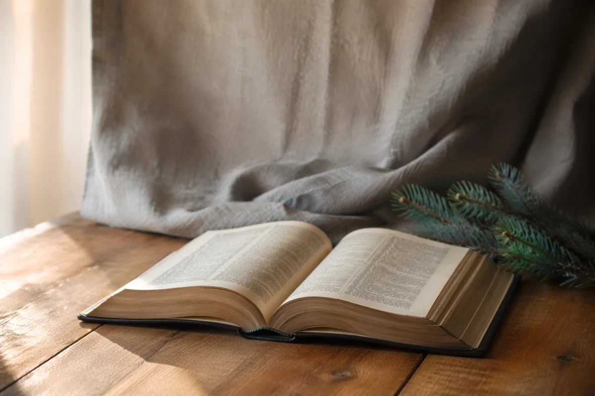 Open Bible on Warm Wooden Table