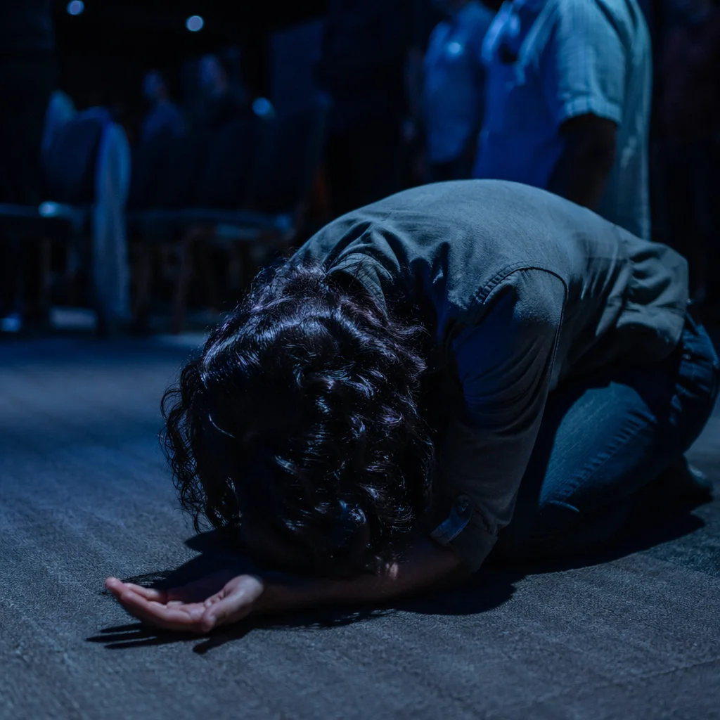 Kneeling Prayer in Blue Chapel Light