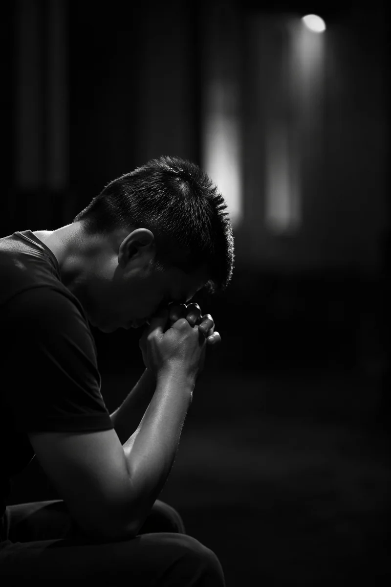 Kneeling Prayer in Quiet Monochrome