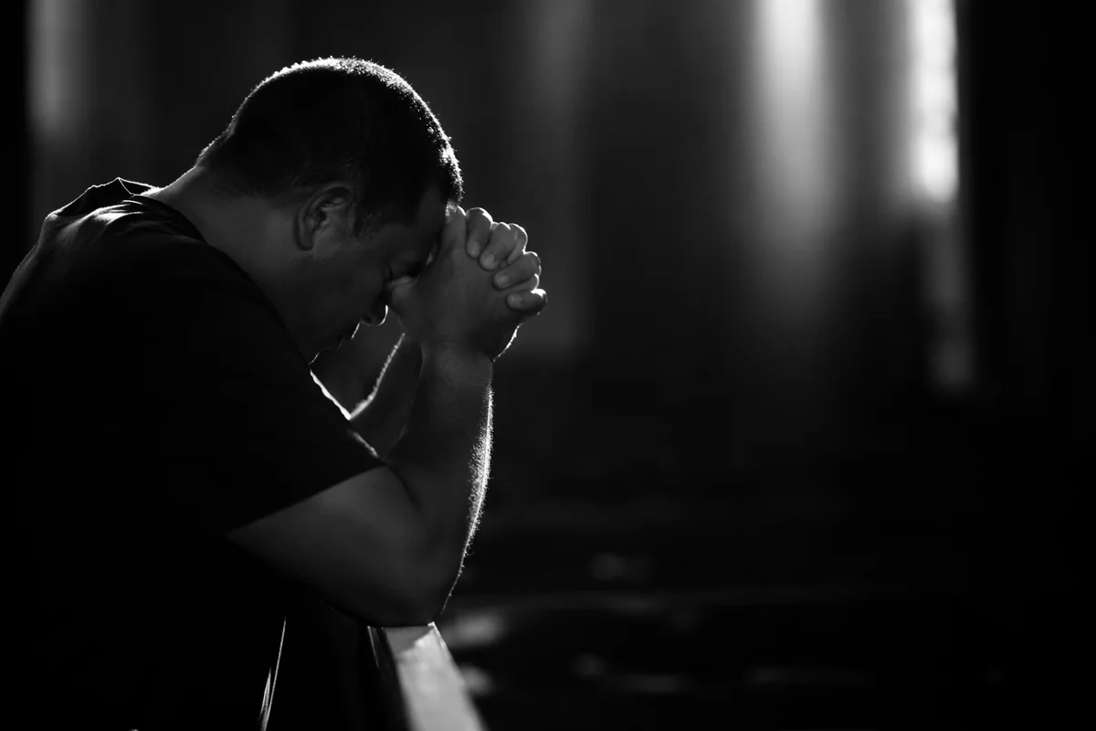 Kneeling Prayer in Quiet Monochrome Light