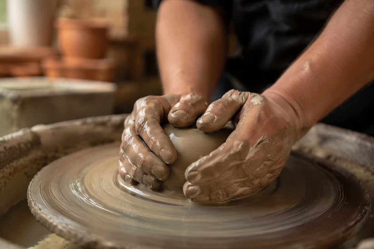 Potter Hands Shaping Clay on Wheel