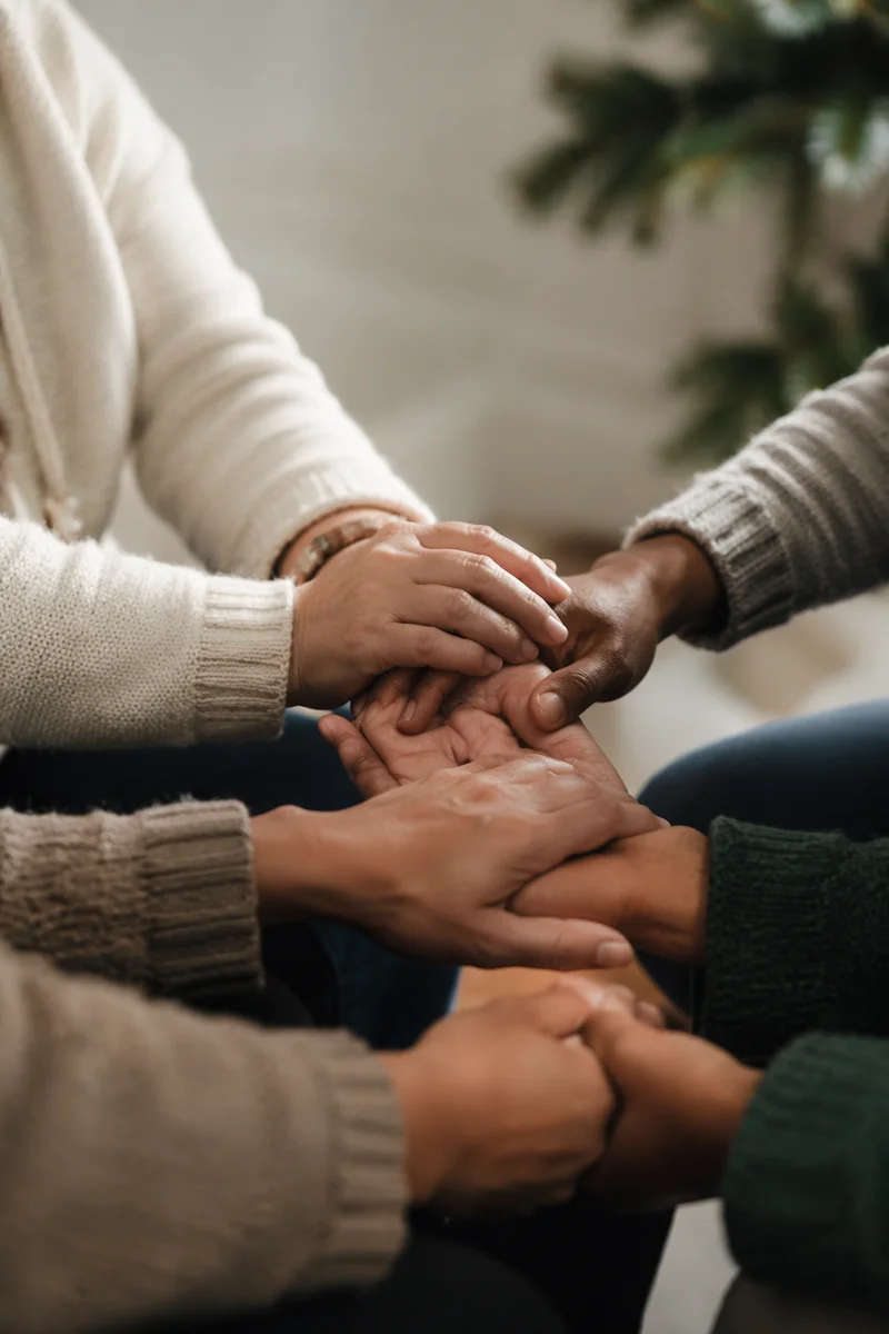 United Prayer Group Hands in Evergreen Light