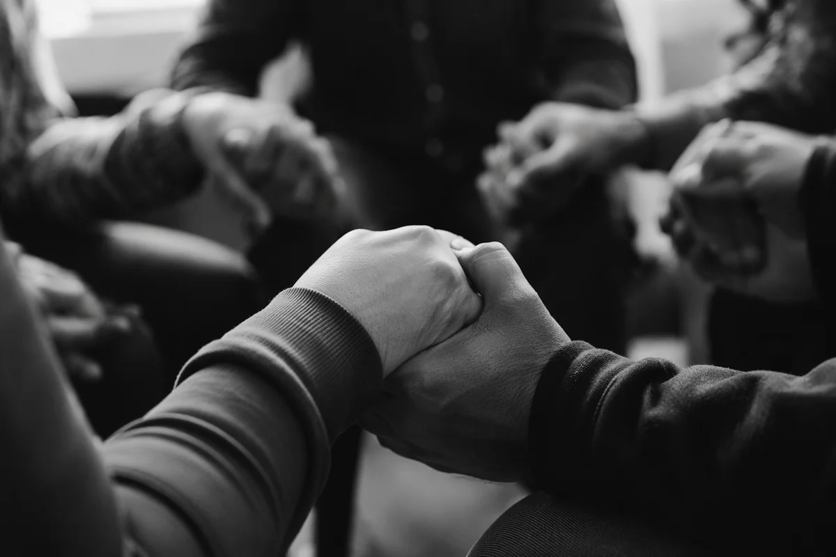 Joined Hands in Quiet Prayer Circle