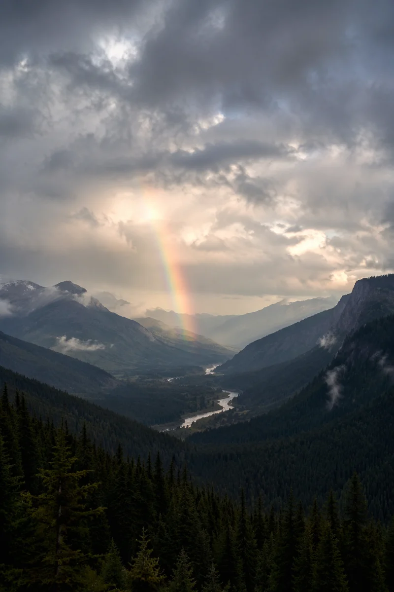 Rainbow Over Stormy Evergreen Mountain Valley