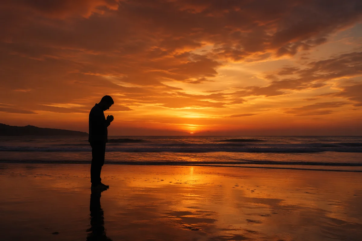 Praying Silhouette on Sunset Shoreline