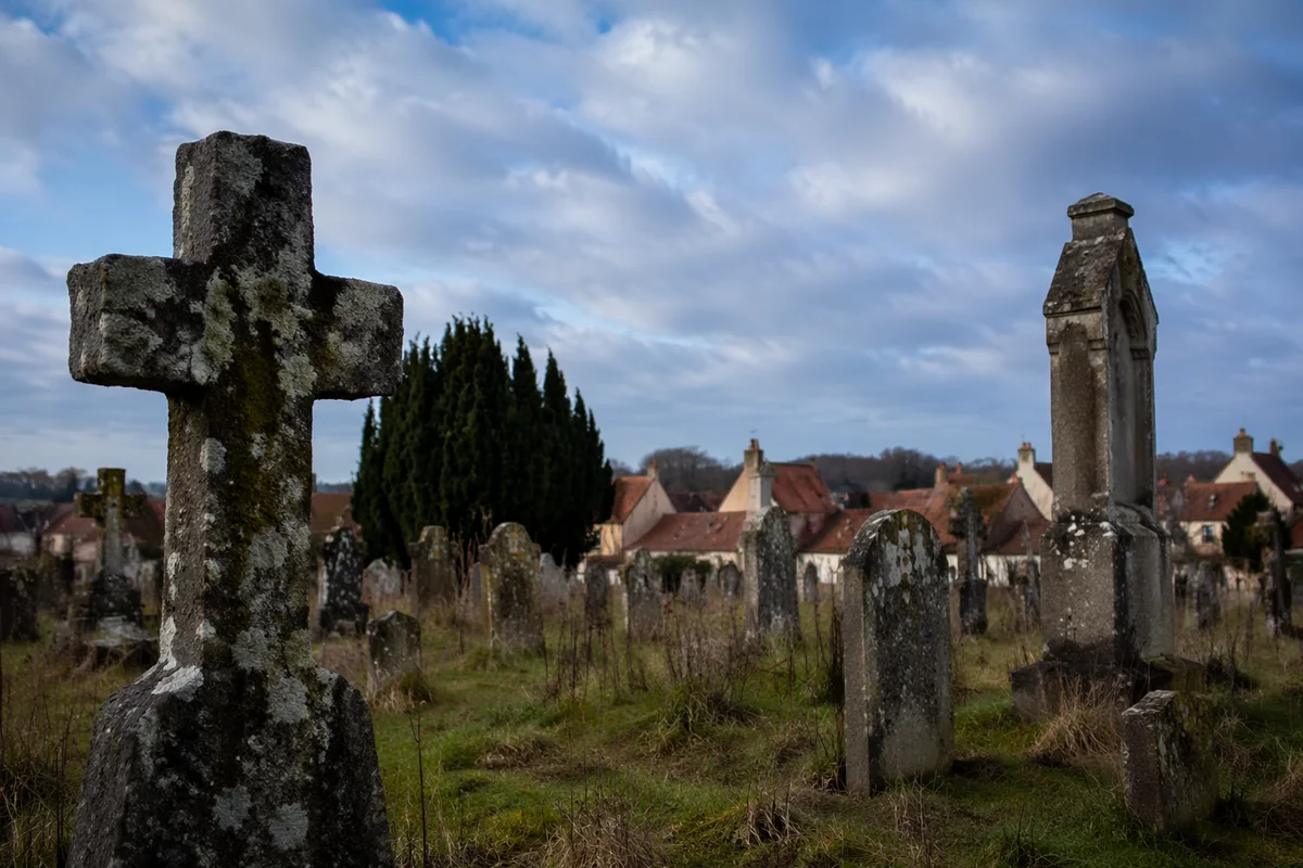 Weathered Stone Cross in Old Rural Cemetery