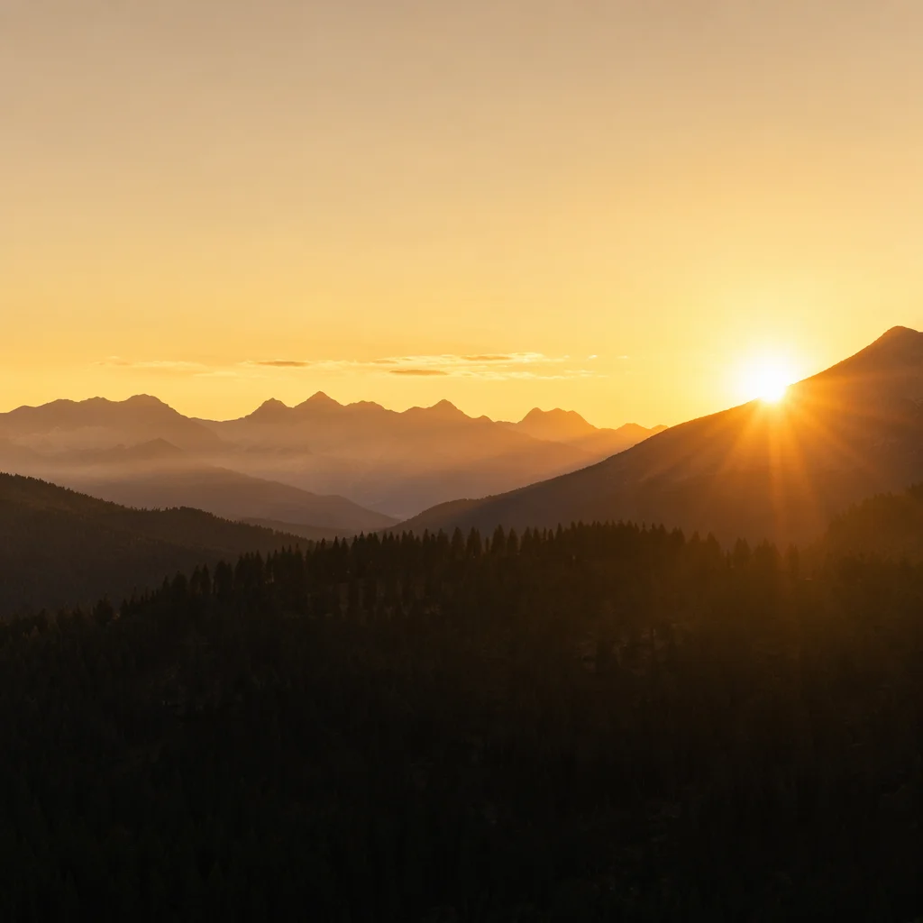 Golden Sunrise Over Evergreen Mountain Range
