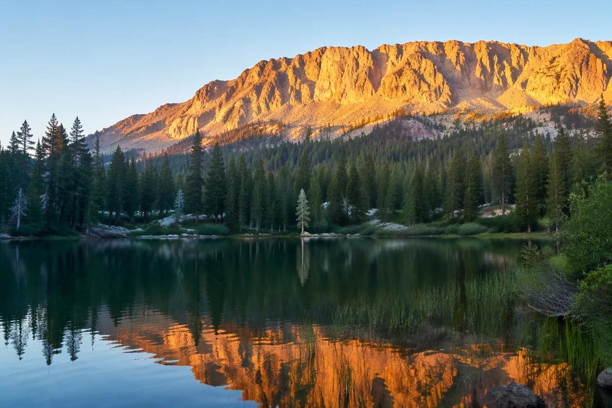 Golden Sunrise Over Evergreen Mountain Lake