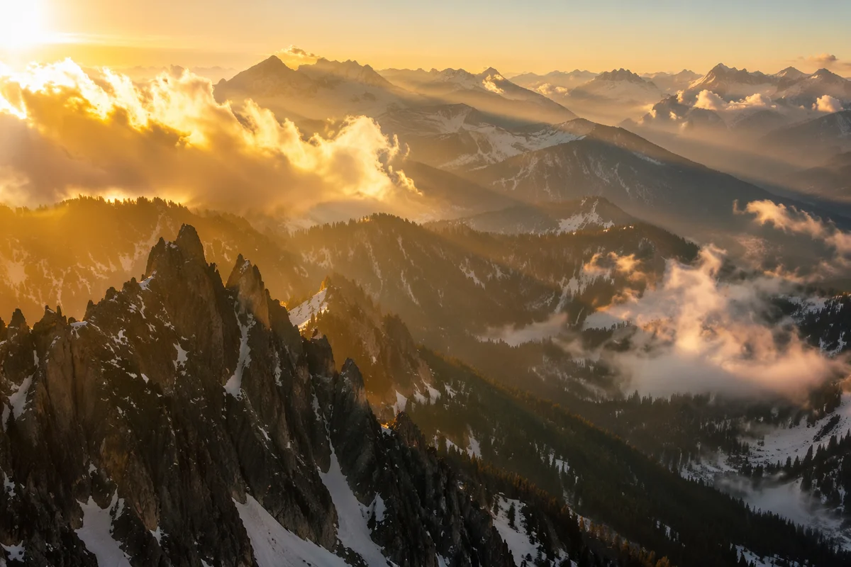 Golden Sunrise Over Evergreen Alpine Peaks