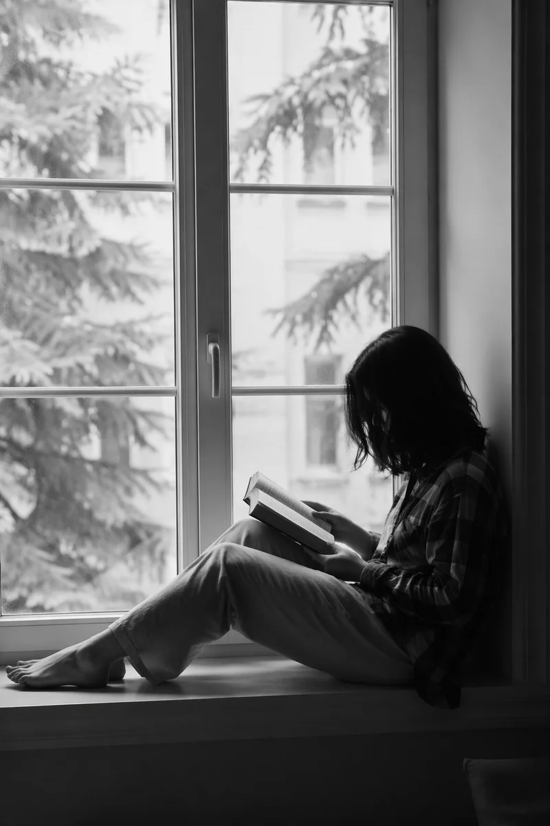 Woman Reading Bible by Quiet Window