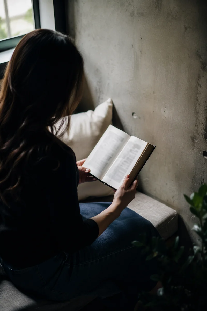Peaceful Woman Reading Bible by Window