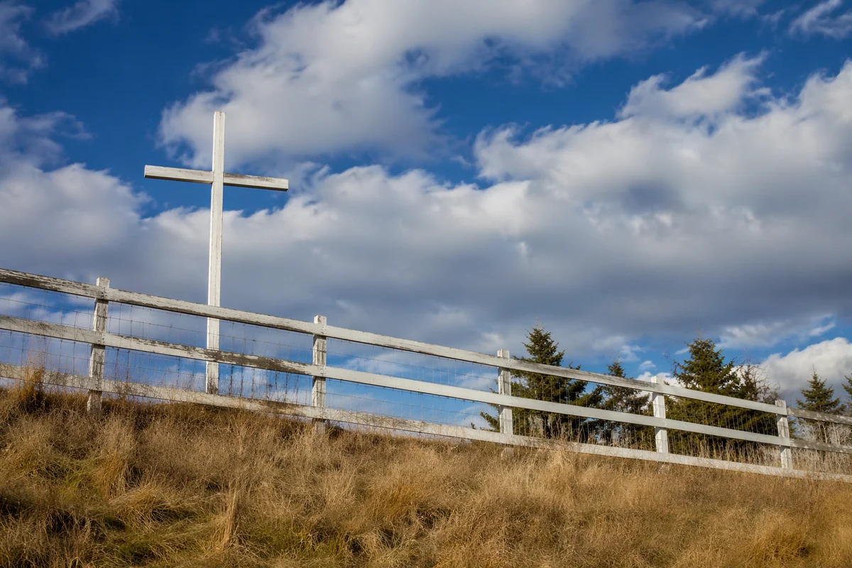 White Wooden Cross on Hilltop Sky