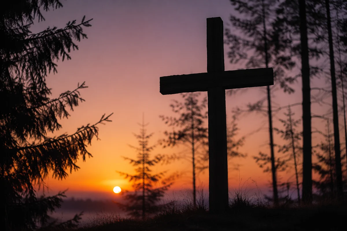 Wooden Cross Silhouette at Evergreen Sunrise