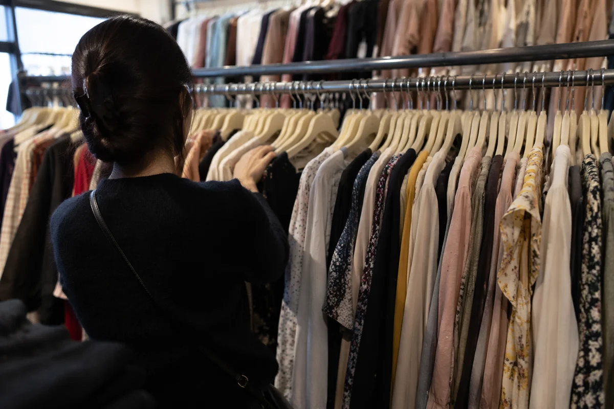 Shopper Browsing Clothing Rack in Boutique
