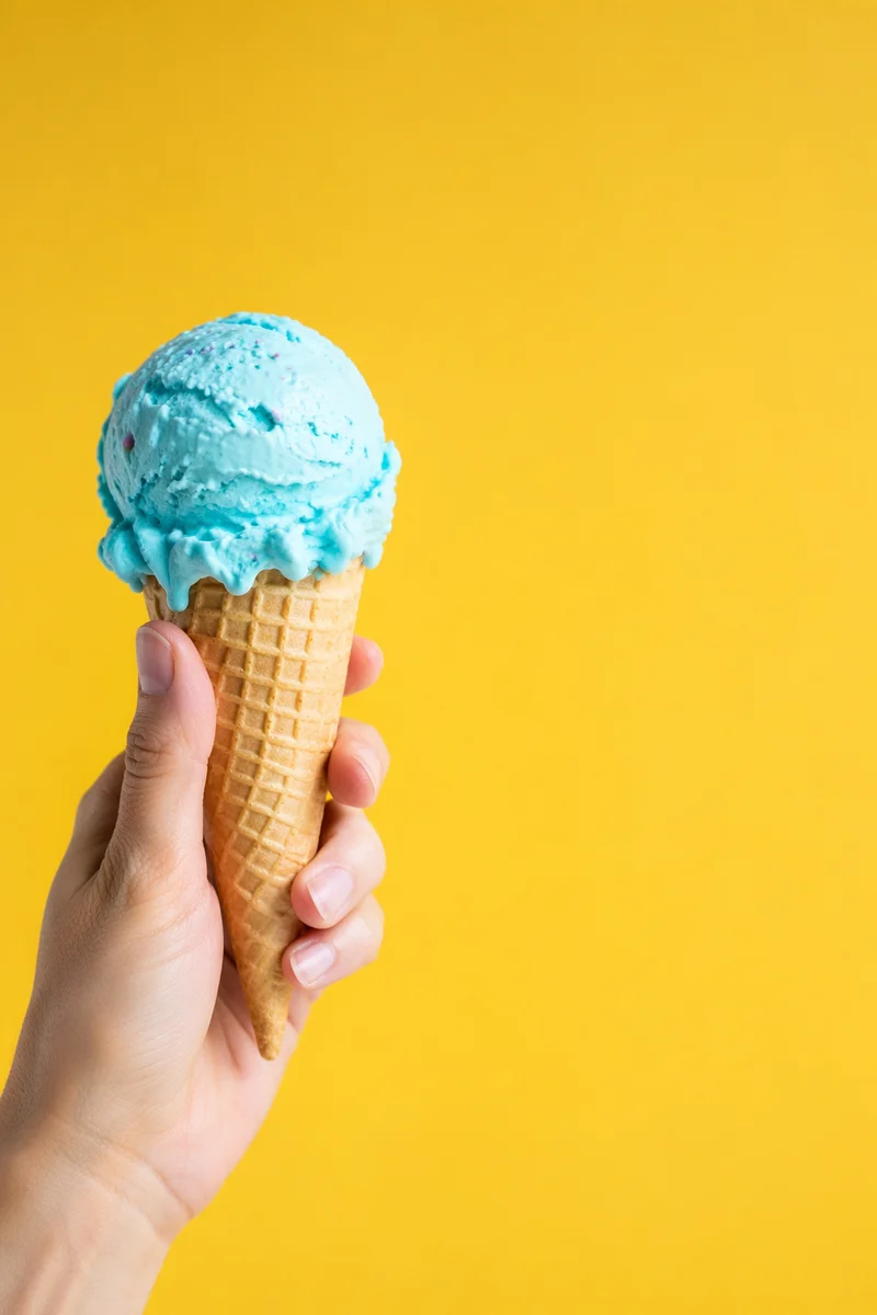 Hand Holding Blue Ice Cream Cone