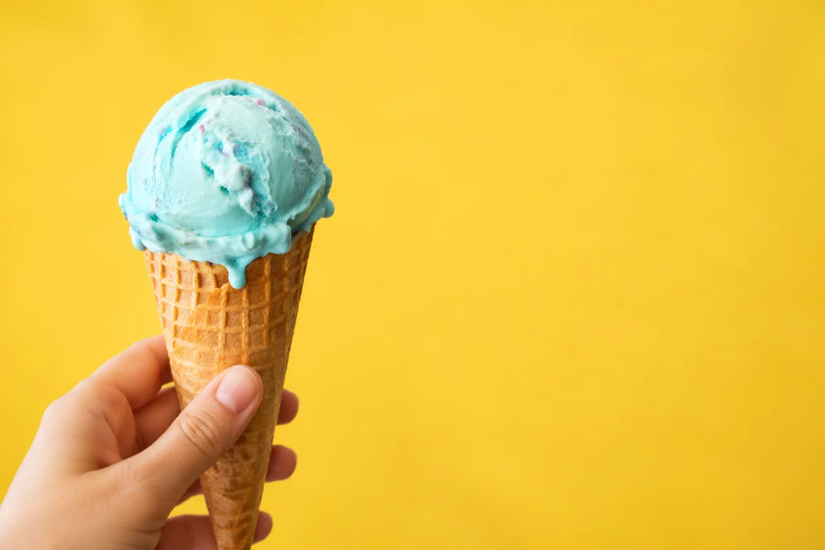 Hand Holding Blue Ice Cream Cone