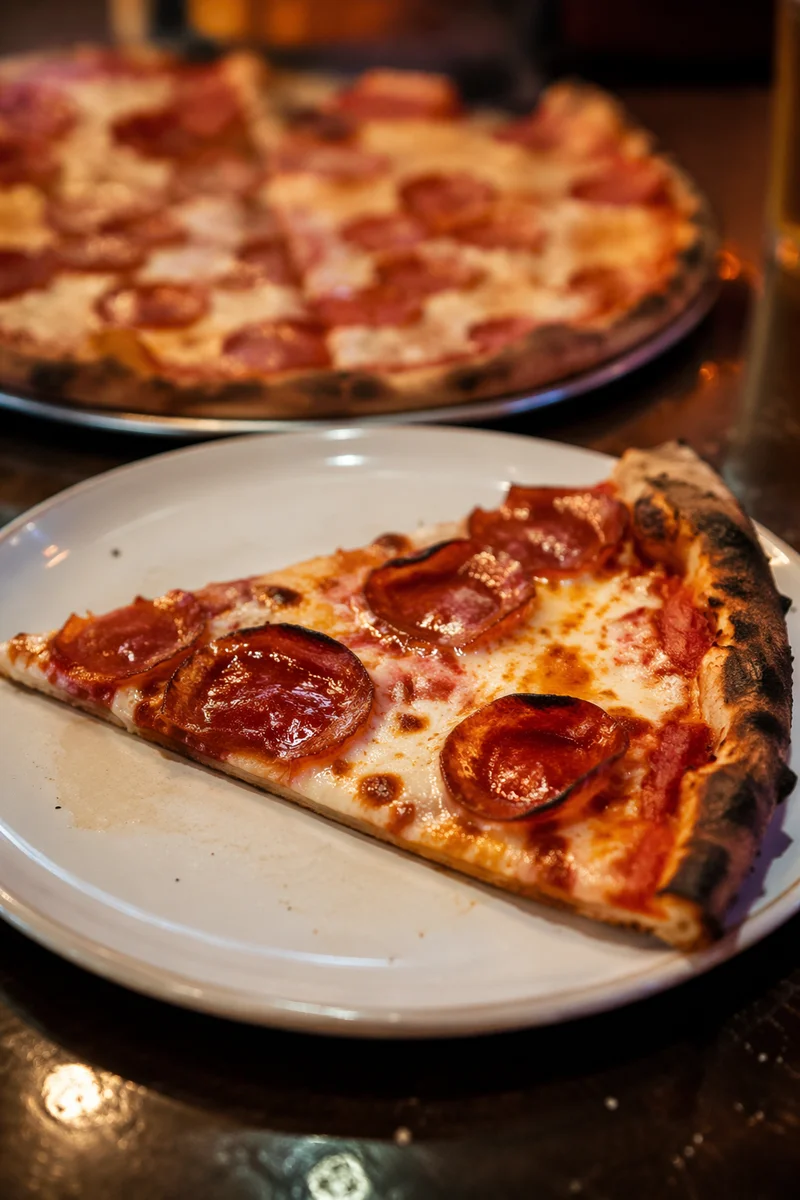 Fresh Pepperoni Pizza Slice on White Plate