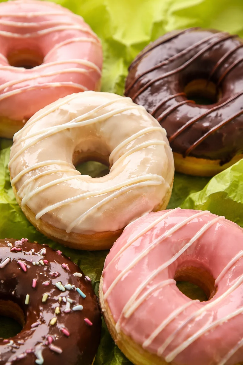 Colorful Glazed Donuts on Lime Parchment