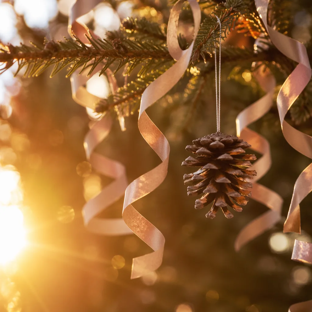 Warm Christmas Pinecone Ornament on Evergreen Branch