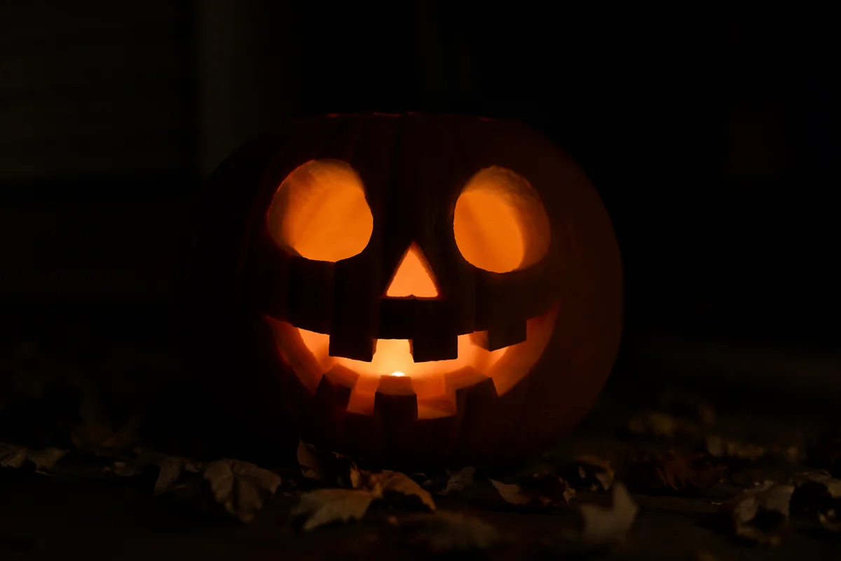 Glowing Jack O Lantern on Dark Porch