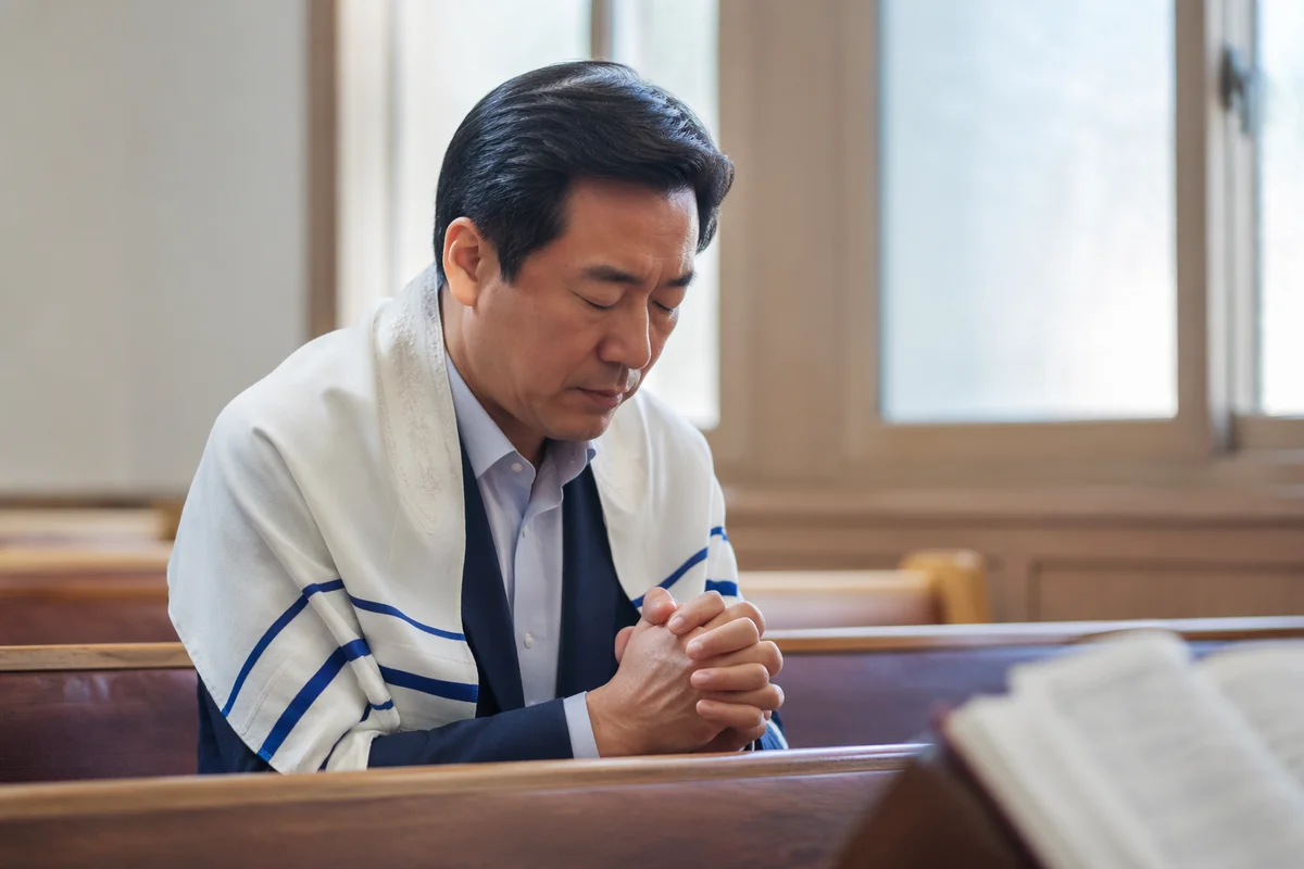 Korean Man Praying in Church Pew