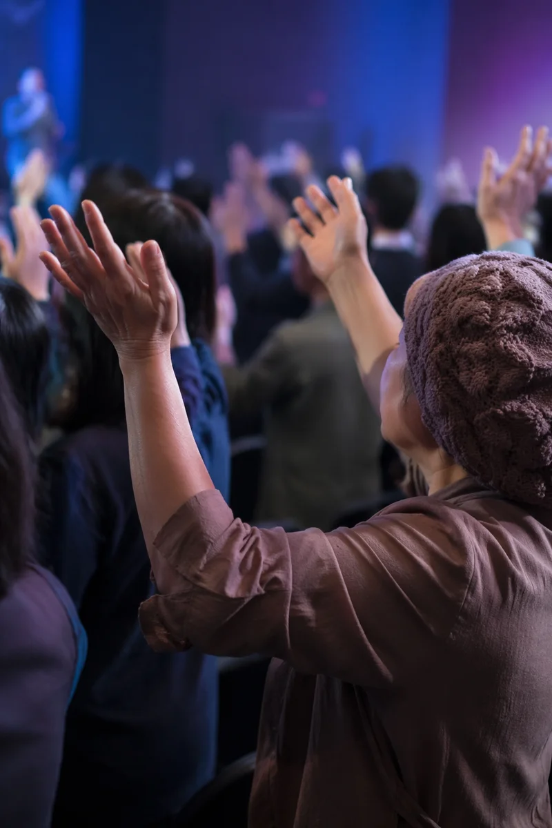 Fervent Prayer Hands at Korean Revival Meeting