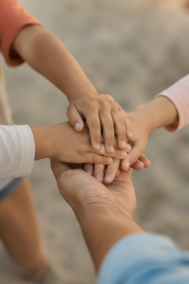 Children Hands United in Sandy Teamwork