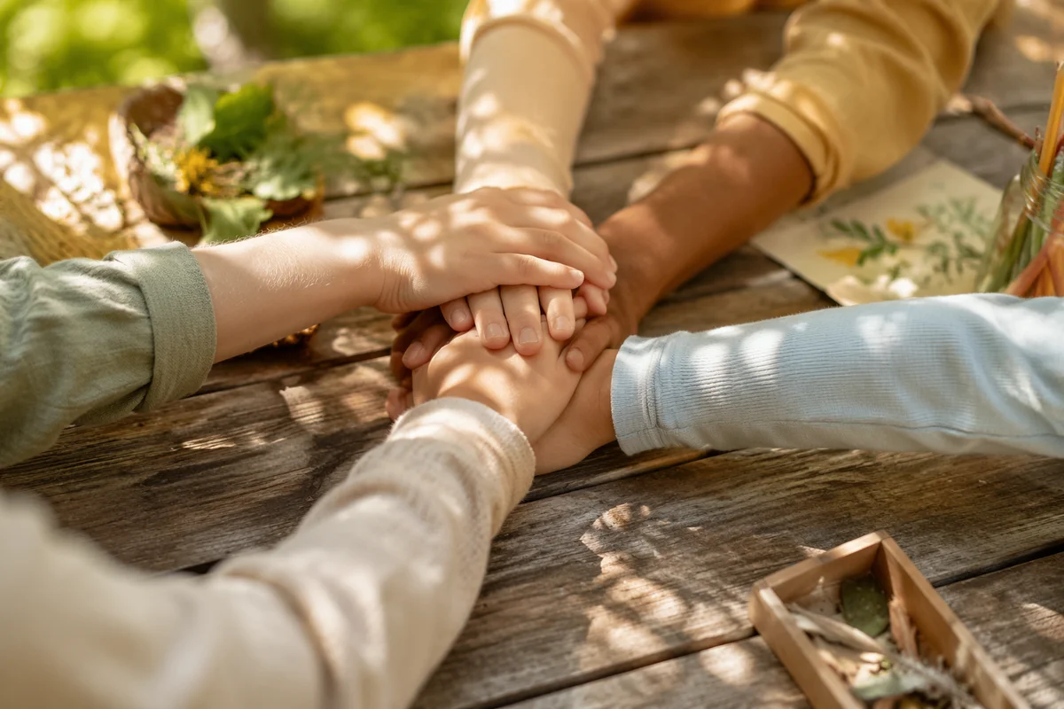 Children Stacking Hands in Garden Teamwork