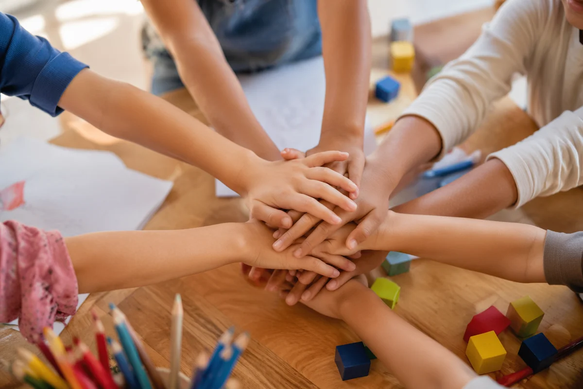 Children Hands Stacking in Teamwork Circle