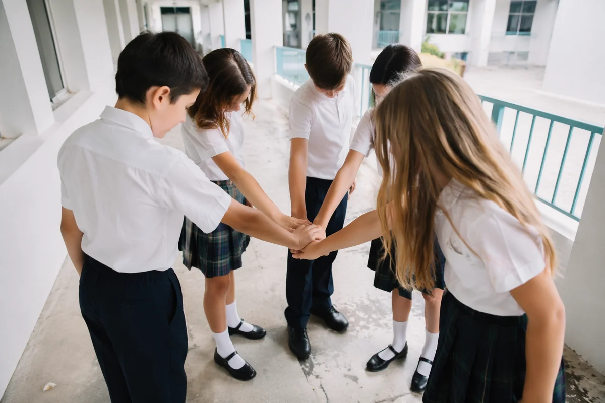 Children Stacking Hands in School Teamwork