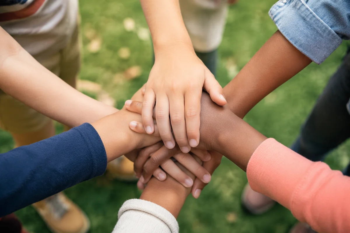 Children Hands Stacked in Joyful Teamwork
