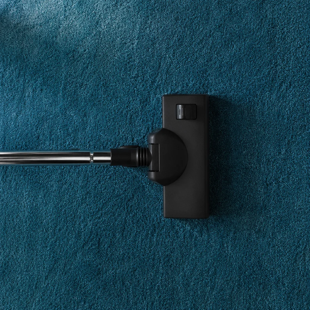Vacuum Cleaner on Teal Carpet