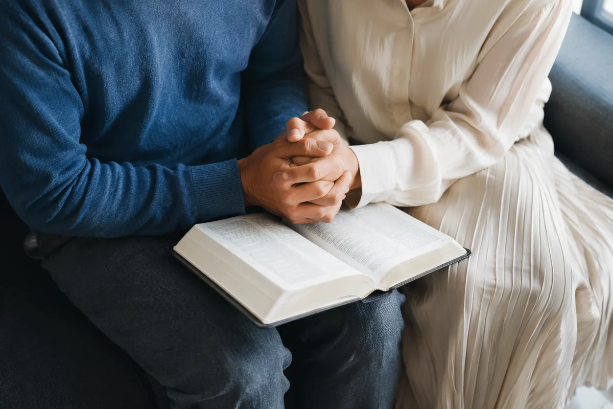 Couple Praying Together in Quiet Reflection