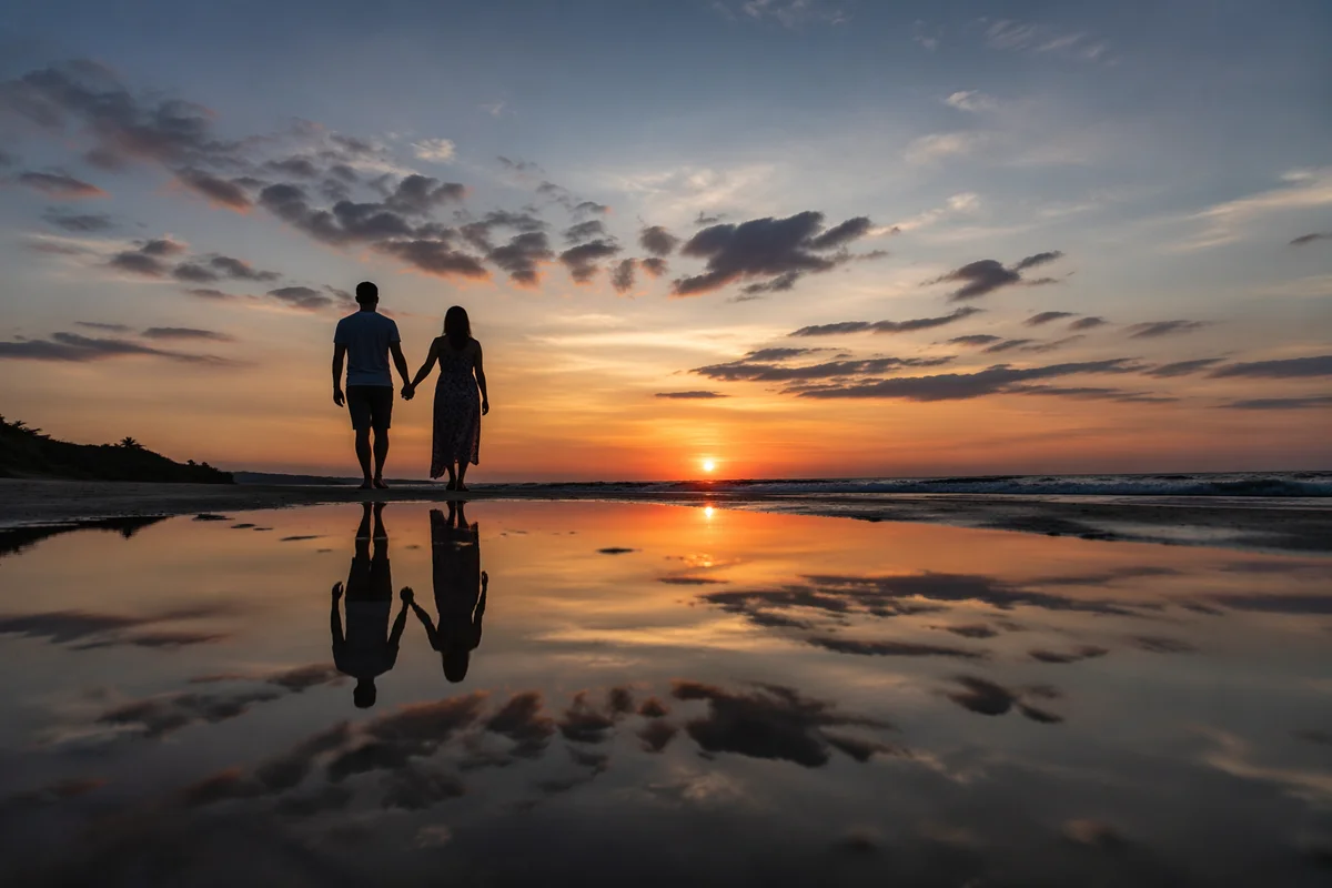 Couple Walking Hand in Hand at Sunset