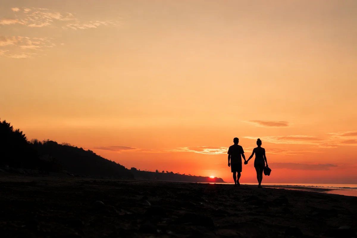 Couple Silhouette Walking on Sunset Beach
