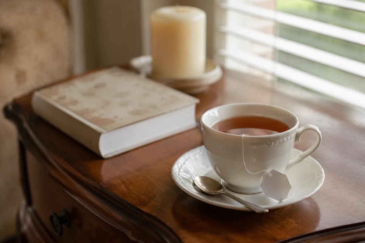 Tea Cup and Book on Wooden Table